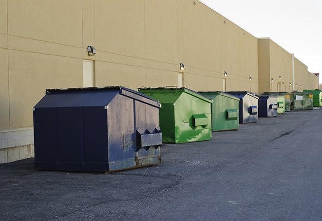 a construction worker moves construction materials near a dumpster in Cibolo TX